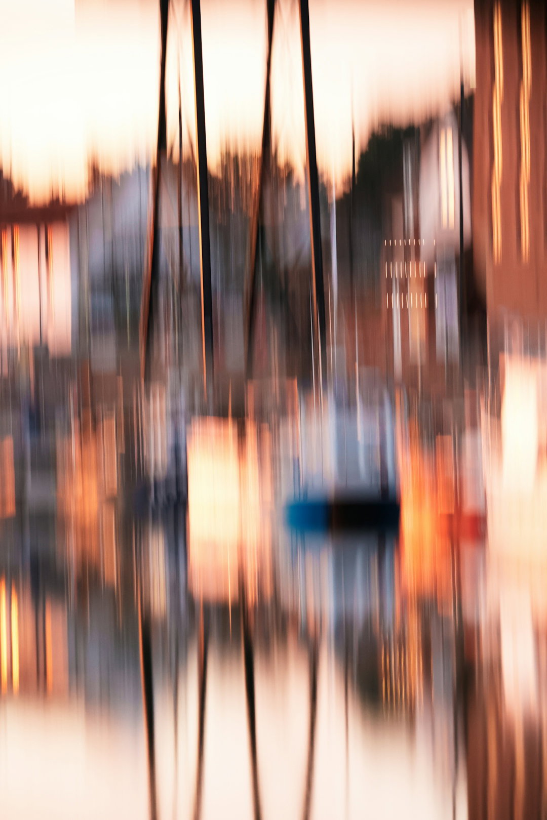 abstract-vertical-motion-blur-of-sailboat-masts-and-warm-light-reflecting-on-water.jpg Abstract vertical motion blur of sailboat masts and warm light reflecting on water